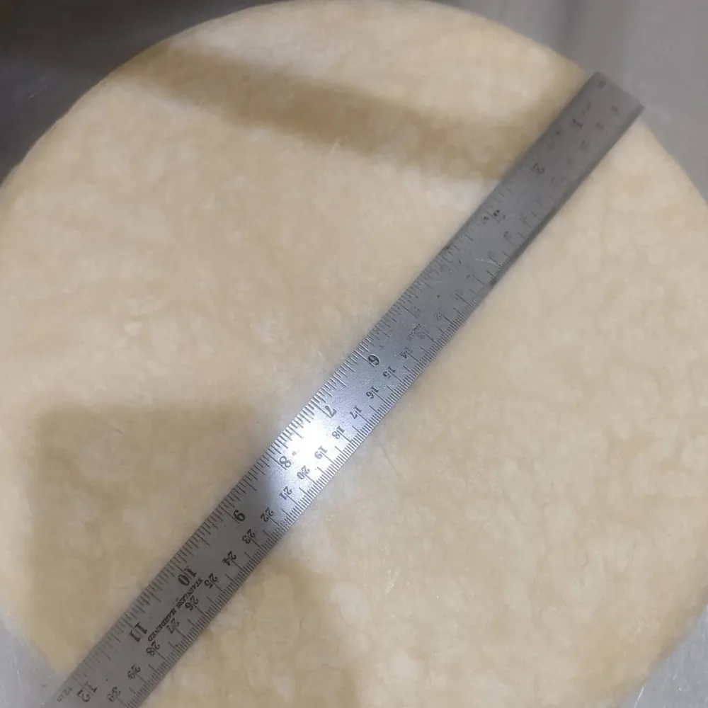 A 12-inch Sunrise Tacos flour tortilla measured with a steel ruler