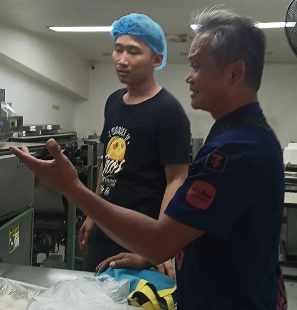 Two Sunrise Tacos staff in the tortilla kitchen in Bangkok