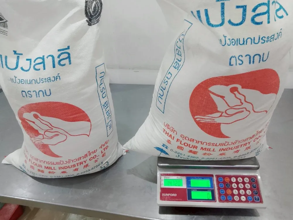 Two sacks of Thai Flour Mill flour on a kitchen scale